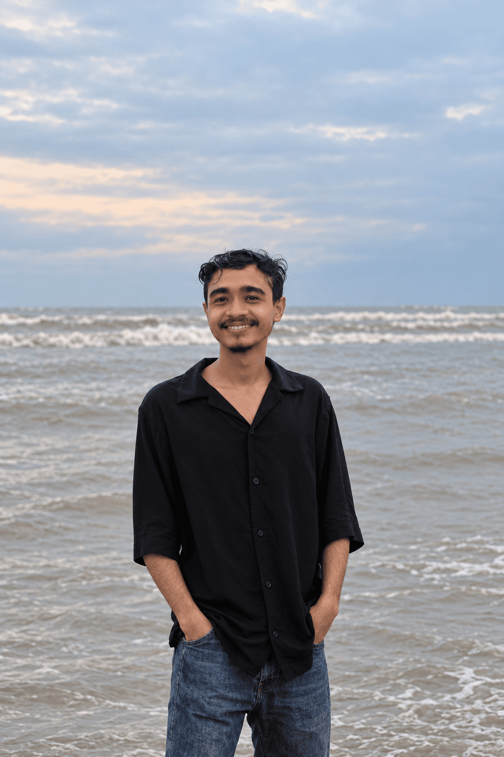 Faisal Hossen standing by the sea